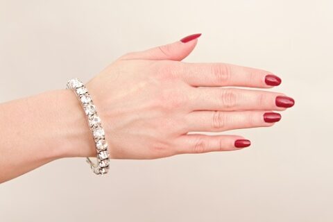 tennis bracelet on manicured hand