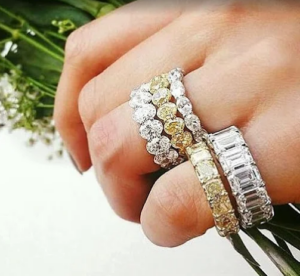 Close up of a hand with diamond rings stacked